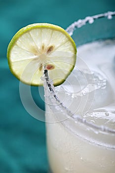 Classic margarita cocktail with lime and salty rim