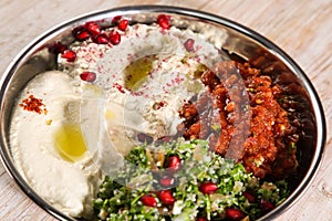 Classic mezza platter with Baba Ganoujm, Turkish Salsa, Labneh, Taboula served in dish isolated on background top of arabic food photo