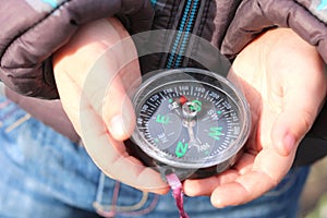 Classic navigation compass in childs hands