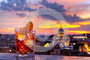 A classic Negroni cocktail with the city of Rome in the background