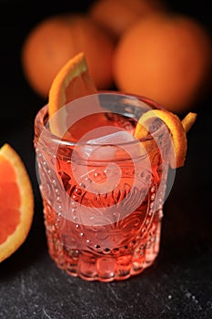 Classic Negroni Cocktail in a Retro Glass with Ice and Sliced Orange