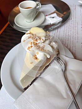 Classic New York cheesecake slice with graham cracker crust and a dollop of whipped cream