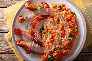 Classic Nigerian Jollofï¿½Rice with fried chicken wings close-up.