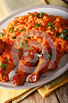 Classic Nigerian Jollofï¿½Rice with fried chicken wings close-up.