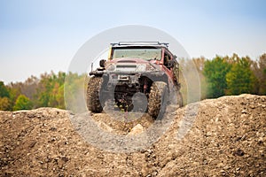 Classic off road car moving on dirt terrain