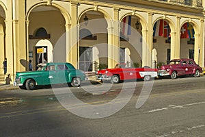 Classic old American cars parked in front of hotel in Old Havana, Cuba