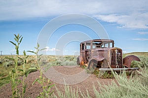 Classic Old Car decays in a meadow.