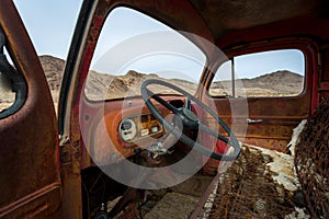 Classic Old Car decays in a meadow.