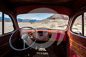Classic Old Car decays in a meadow.