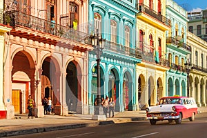 Classic old cars and colorful buildings in downtown Havana