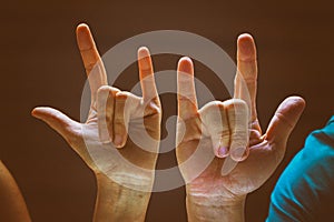 The classic old film design background of human hands in Rock and Roll sign and symbo