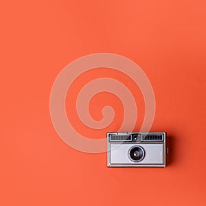 Classic old Photo Camera on orange background