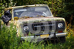 Classic old rusty 4x4 adventure truck in the forest