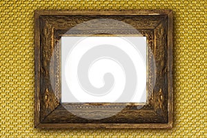 Classic old wooden picture frame carved by hand on gold wallpaper
