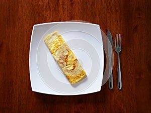 Classic omelet on the white plate. Fresh breakfast..