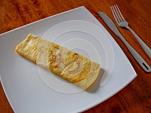 Classic omelet on the white plate. Fresh breakfast..
