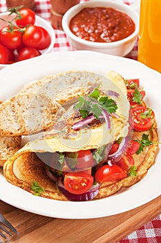 Classic omelete with toasted bread and cherry tomato