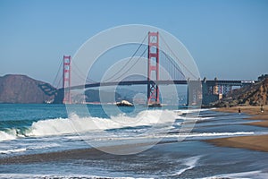 Classic panoramic view of famous Golden Gate Bridge seen from Baker Beach in beautiful summer sunny day with blue sky, San