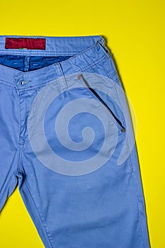 Classic pants. Blue classic trousers on a yellow background. Men`s fashion.