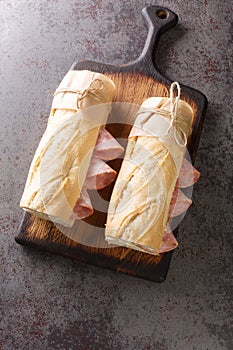 Classic Parisian Jambon-Beurre Sandwich closeup. Vertical top view