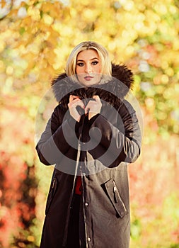 Classic parka coat has become wardrobe icon. Versatile functional and stylish. Girl wear parka while walk park. Autumn