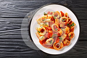 Classic Pasta Calamarata with squid sauce Italian Recipe close-up in a plate. Horizontal top view