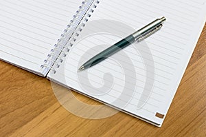 Classic pen and notebook on wooden desk