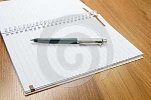 Classic pen and notebook on wooden desk