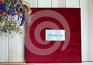 Classic photo book in burgundy velvet cover.