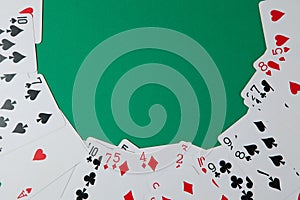 Classic playing cards on green background. Gambling and casino concept.