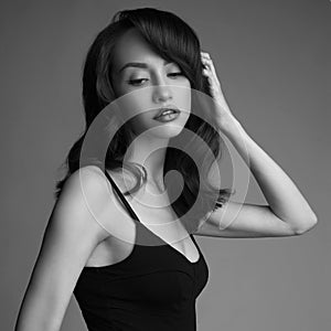 Classic portrait of beautiful young pretty lady in black dress