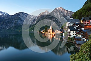 Classic postcard view of famous Hallstatt lakeside town reflecting in Hallstattersee lake in the Austrian Alps in scenic morning l