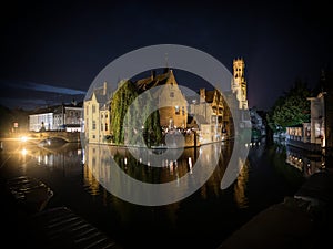 Classic postcard view illuminated historical medieval buildings Rozenhoedkaai Dijver canal belfry belfort Bruges Belgium
