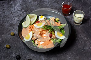 Classic Prawn Cocktail with boiled egg, dip and tomato sauce served in dish isolated on grey background top view of indian and