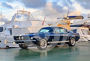 Classic rare American muscle car, vintage blue Ford Mustang Shelby Cobra GT-500 Fastback on a pier in Palma de Mallorca in