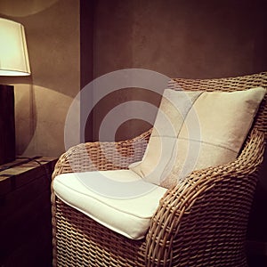 Classic rattan armchair and cozy lamp