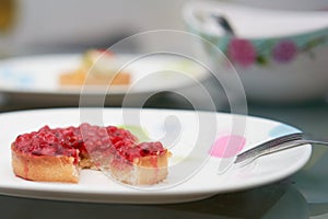 Classic red berry curd tart on plate on table with copy space