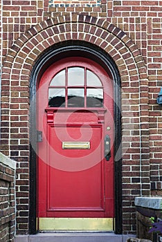 Red door of a house in Brooklyn in New York City, USA