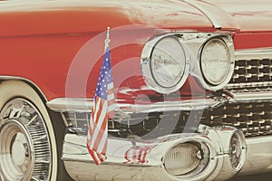 Classic red front of an old car with the American flag