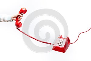 Classic red telephone receiver in hand