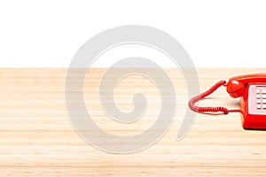 Classic red telephone on wooden desk