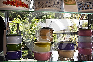 Classic retro vintage colorful pastel tiffin food carriers or dabbas or lunch box on shelf for show and sale at modern shop in