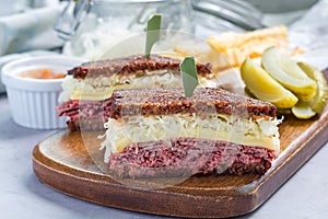 Classic reuben sandwich, served with dill pickle, potato chips, horizontal