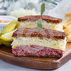 Classic reuben sandwich, served with dill pickle, potato chips, square format