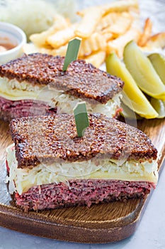 Classic reuben sandwich, served with dill pickle, potato chips, vertical