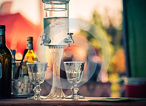 Ritual of glass of absinthe and dripping fountain