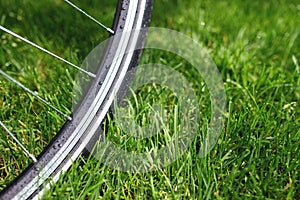 Classic road bicycle close-up photo in the summer green grass meadow field. Travel background