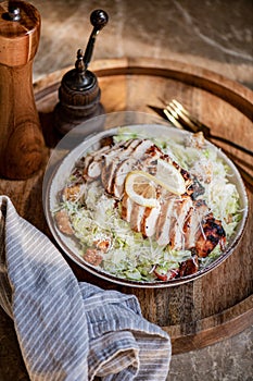 Classic roasted chicken Caesar salad bowl with croutons and parmesan