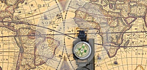 Classic round compass on background of old vintage map of world
