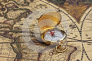 Classic round compass on background of old vintage map of world